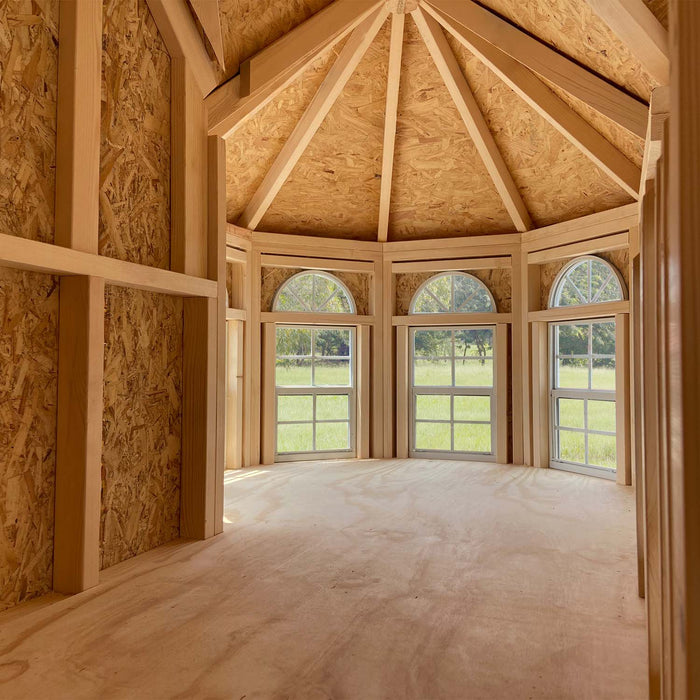Interior view of Grand Portico Mansion playhouse by Little Cottage Co. with vaulted ceiling and tall arched windows bringing in natural light