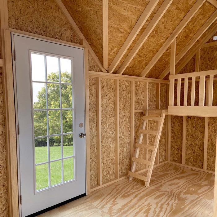 Inside Grand Portico Mansion playhouse from Little Cottage Co. featuring loft with ladder, French door, and natural wood interior structure