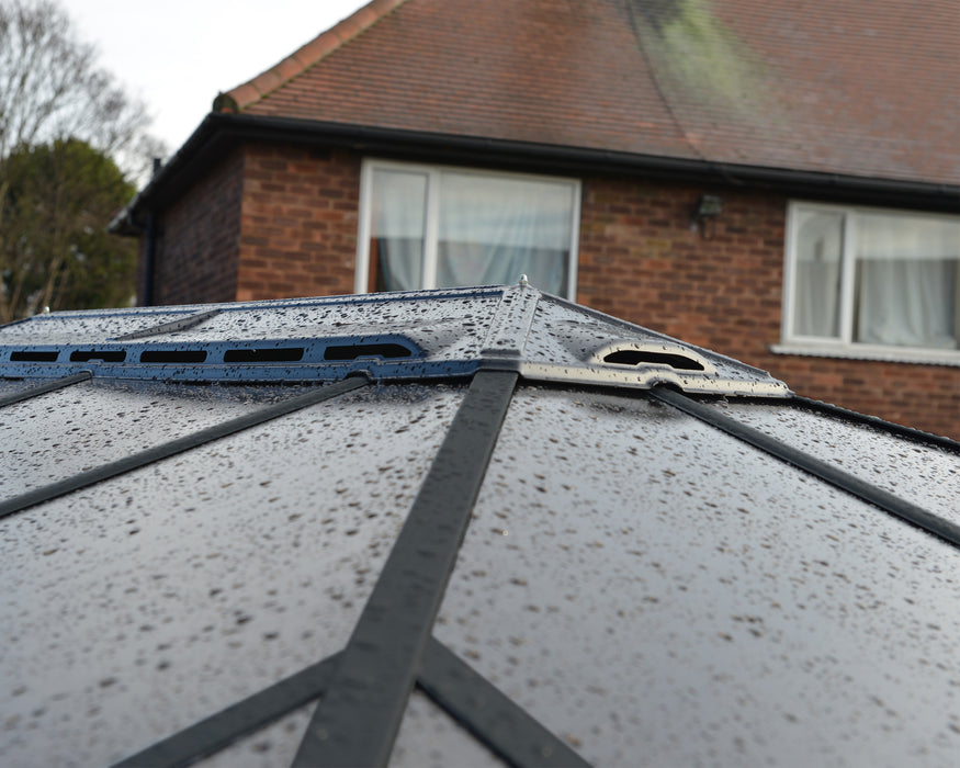 Close-up view of the Canopia Ledro gazebo roof vent showing its weatherproof, durable gray panels with raindrops.