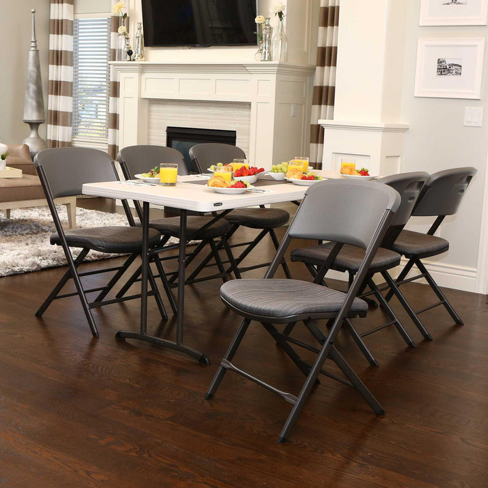 Gray Lifetime padded folding chairs from 4 pack placed around rectangular folding table indoors.