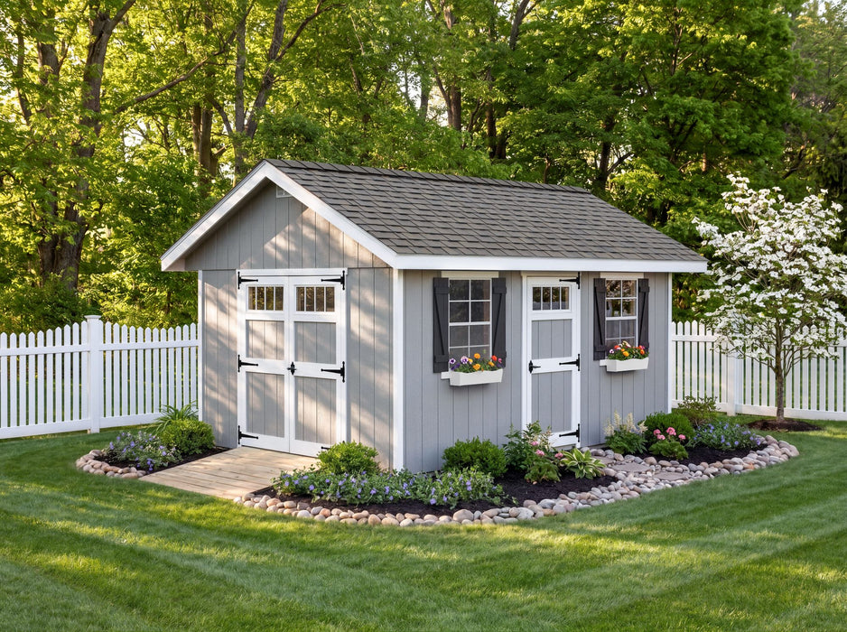 Fully assembled Ez-Fit Kits Riverside Outdoor Garden Shed in gray with white doors, black shutters, flower boxes, and landscaped garden beds