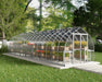 Exterior view of the Canopia Bella 8' x 32' Greenhouse showcasing vibrant plants and greenery