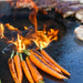 Arteflame Black Label 40" Grill Cooktop with fire bowl in action, perfectly grilling a variety of vegetables and meats.