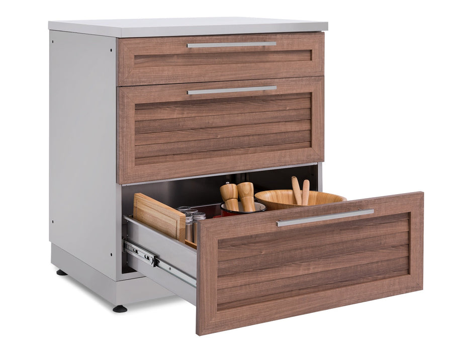 Bottom drawer of the NewAge Classic 3-Drawer Cabinet open and styled with a wood cutting board, salt and pepper mills, and a serving bowl.