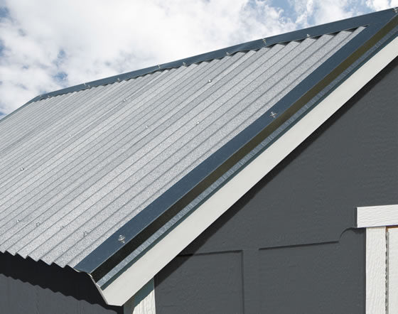 Close-up of Handy Home 10x8 Acadia gray metal roof with exposed fasteners on a gray shed with white trim.