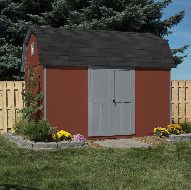 Handy Home Briarwood Wood Storage Shed Kit in red with grey double doors, placed in a landscaped backyard.