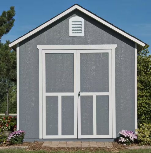 Front view of a Handy Home Meridian gray storage shed with large double doors, set in a landscaped garden.