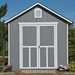 Front view of a Handy Home Meridian gray storage shed with large double doors, set in a landscaped garden.