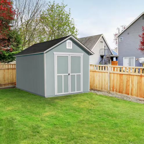 A Handy Home Meridian shed positioned in a green backyard, seamlessly blending with the residential setting.