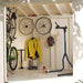 Handy Home Palisade shed interior used as organized bicycle storage with bikes, wheels, and gear. 