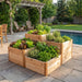 A 3.5x4 Tiered Raised Garden Bed growing fresh lettuce and herbs on a stone patio next to a swimming pool.
