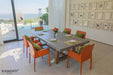 lementi Seine Series rectangular dining table in a bright indoor dining room, set with colorful chairs and tableware.