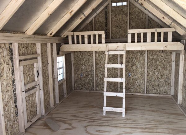 Interior view of the Pennfield Cottage Playhouse by Little Cottage Company, highlighting the cozy loft space inside.