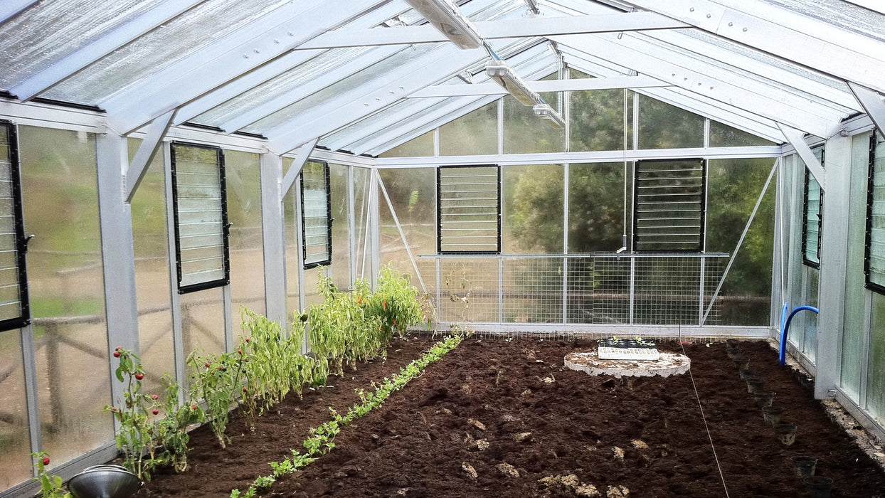 Interior of Exaco Janssens Gigant Greenhouse showing soil planting beds and ventilation windows