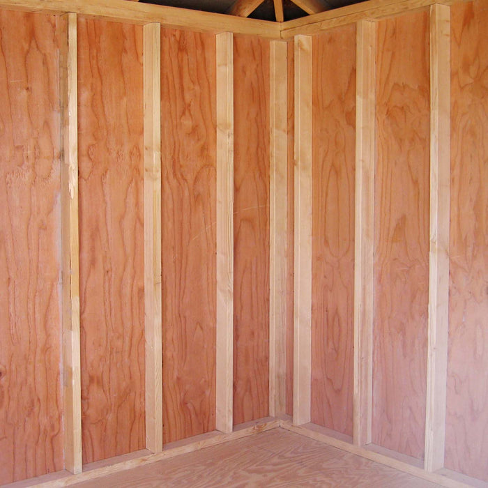 Interior view of Little Cottage Co. Classic Five Corner Shed showing unfinished wood framing, plywood walls, and angled roof trusses for support