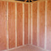 Interior view of Little Cottage Co. Classic Five Corner Shed showing unfinished wood framing, plywood walls, and angled roof trusses for support