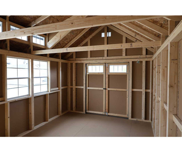 Interior view of Ez-Fit Skyview Shed Kit showing tall gable roof, wood framing, side windows, and double door entry for storage.