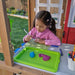 Kid drawing inside the wooden workshop playset