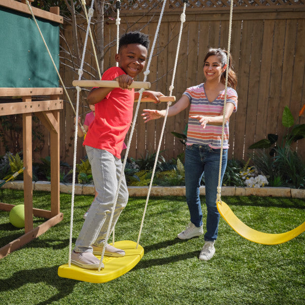 Kids having fun on the swing of the hideaway playset