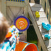 Kid playing a nerf on the outdoor swing set