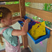 A kid playing inside the cove playset by Kidkraft