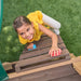 Kid climbing on the outdoor playset for kids