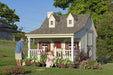 Children happily gardening outside the charming Pennfield Cottage Playhouse by Little Cottage Company.