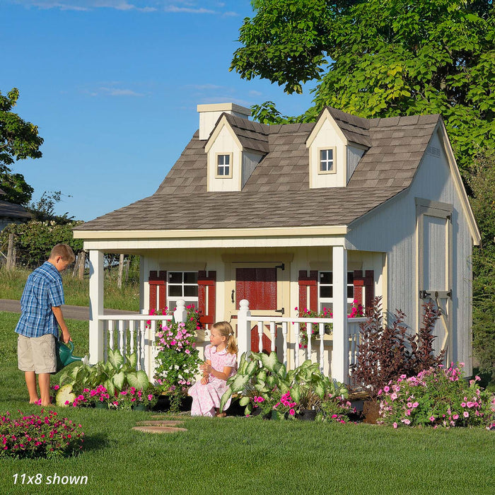 Children happily gardening outside the charming Pennfield Cottage Playhouse by Little Cottage Company.