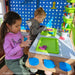 Kids playing clay inside the wooden playset