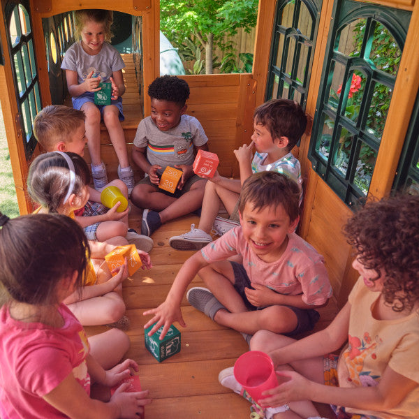 Kids are playing inside the cave lodge playset