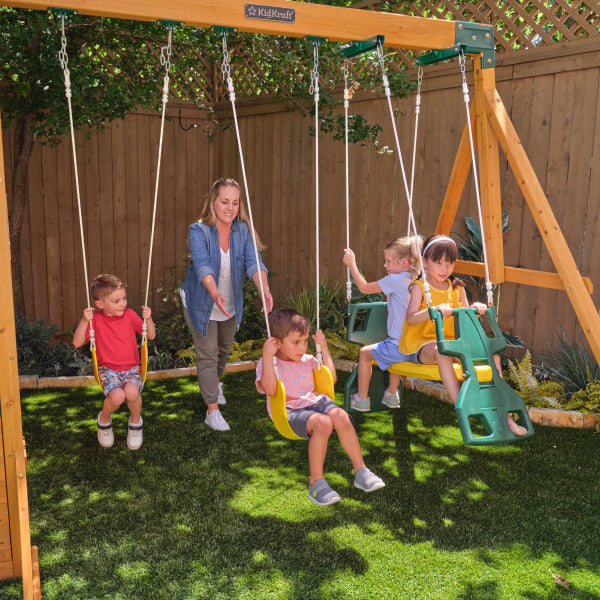 Kids swinging on the wooden bear cave lodge