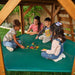 Kids playing on the lower clubhouse of the swing set