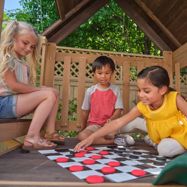 Kids playing inside the outdoor hideaway playset