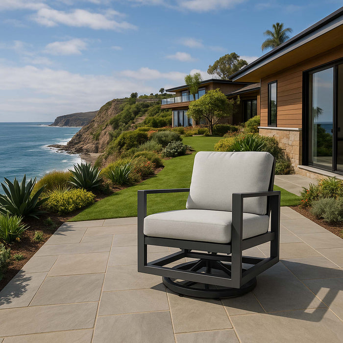 A modern swivel chair from the Elementi Laguna Collection, providing a comfortable and stylish seating option on an oceanfront patio.