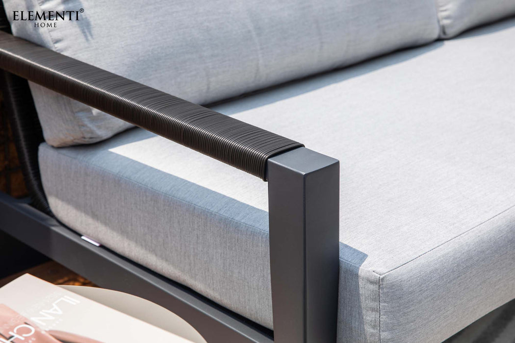 Detail of an Elementi Laguna outdoor chair, focusing on the sleek armrest design and plush grey cushion for ultimate comfort.