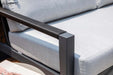 Detail of an Elementi Laguna outdoor chair, focusing on the sleek armrest design and plush grey cushion for ultimate comfort.