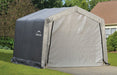 Large gray ShelterLogic peak shed set up in front of a house. This outdoor shelter provides enough space for storing lawnmowers, patio furniture, tools and more