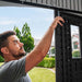 A man demonstrating the latch locking mechanism inside the Lifetime 8x5 Shed.