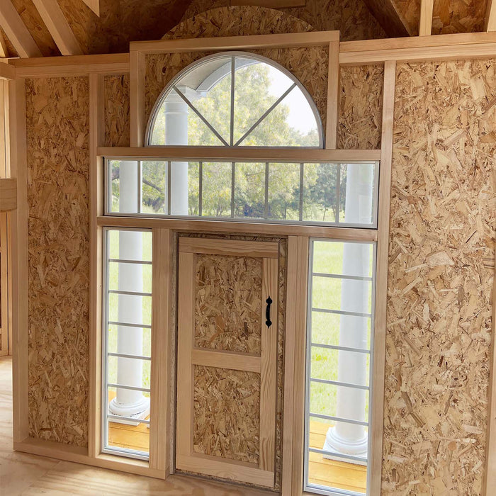 A look inside the Little Cottage Company's Grand Mansion, featuring the lofted play area and multiple windows.