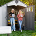 Two women interacting and smiling inside a Lifetime 8x10 Shed, emphasizing the shed's functional and social usage.