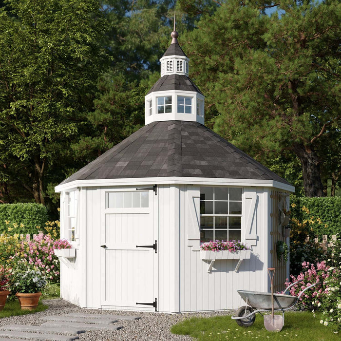 The 12x12 Garden Shed Greenhouse placed in a landscaped garden scene by Little Cottage Co.