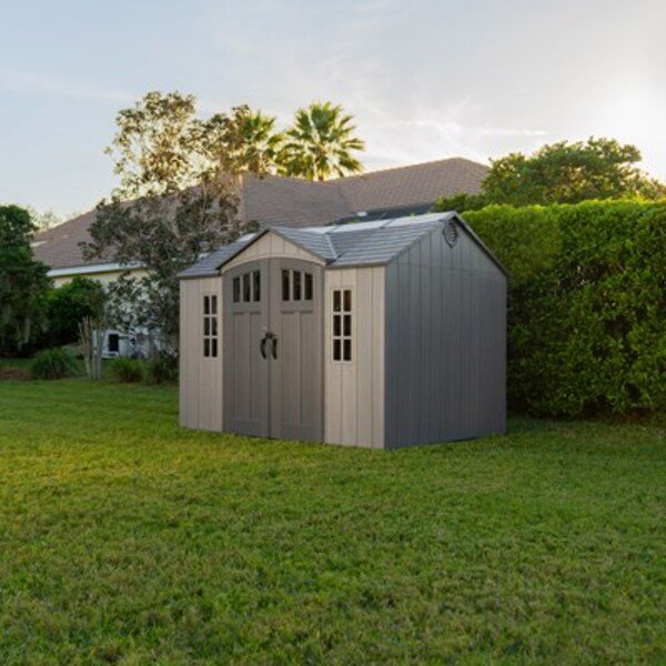 Lifetime 10x8 ft. side entry storage shed installed in a backyard with palm trees, front angle, closed doors.