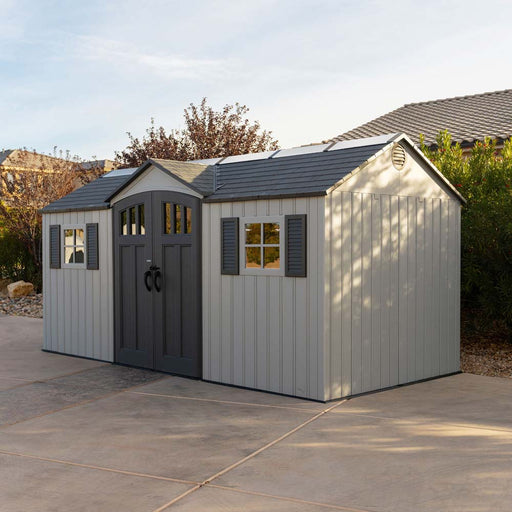 Lifetime 15 x 8 Outdoor Storage Shed from the outside, showing double doors, windows, and the sturdy roof design.