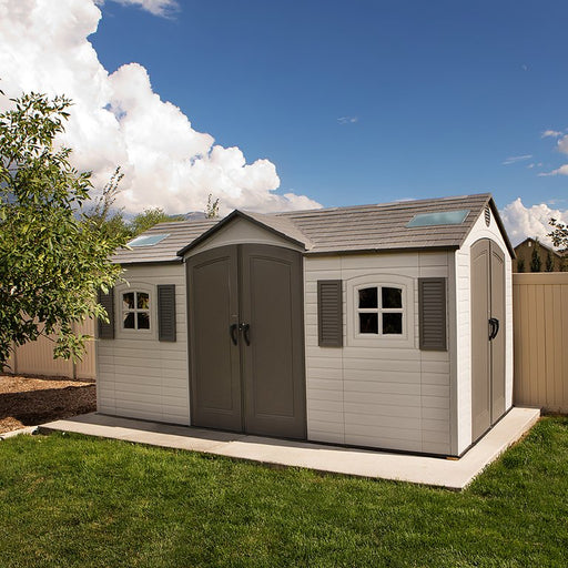 Lifetime 15x8 ft. dual entry storage shed installed in a backyard, front angle view with mountain backdrop.