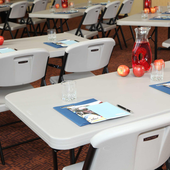 Lifetime 18 Pack Professional Folding Table 6 ft arranged in classroom style meeting setup with chairs and place settings