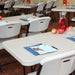 Lifetime 18 Pack Professional Folding Table 6 ft arranged in classroom style meeting setup with chairs and place settings