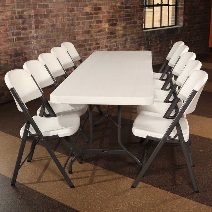 Lifetime 4 Pack 8-Foot Rectangle Folding Table set up with eight white folding chairs for meetings or events
