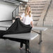 Woman placing black tablecloth on Lifetime 4 Pack Professional Folding Table in putty color for event setup
