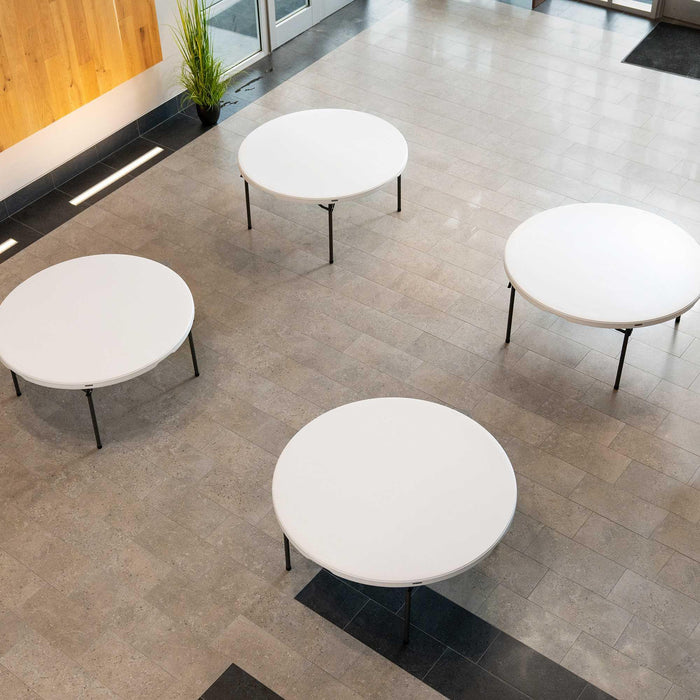 Four Lifetime 4 Pack 60 Inch Round Nesting Tables arranged in event space with full circle seating layout