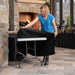Lifetime 4 Pack 6-Foot Rectangle Folding Table covered with black tablecloth near outdoor fireplace